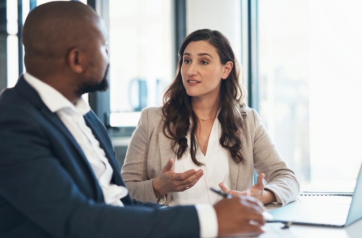 Advice, woman and man in business meeting with laptop consulting on financial plan or audit report. Accounting, finance and businessman with tax advisor, paperwork for review or feedback in office.