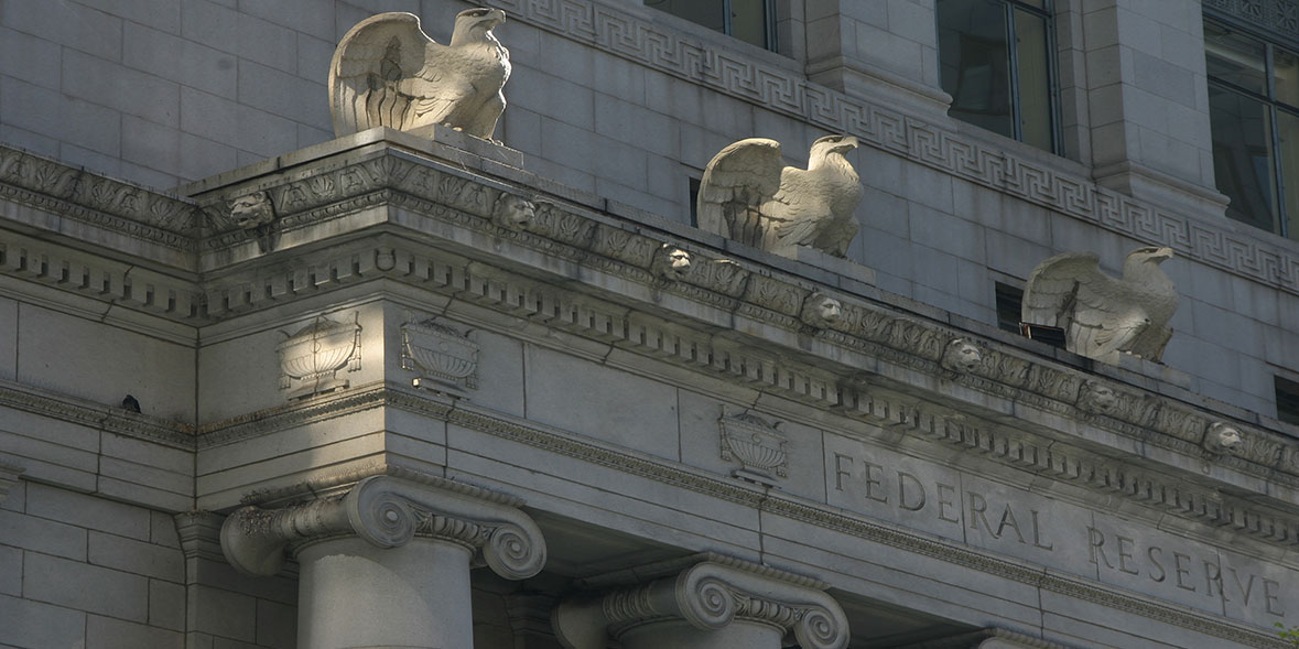 Close-up of three eagle sculptures above a Federal Reserve entrance