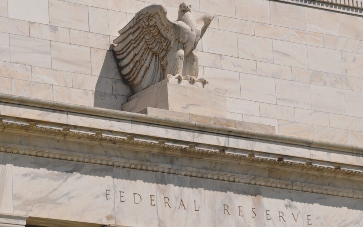 Close-up of eagle statue near the top of the Federal Reserve's facade